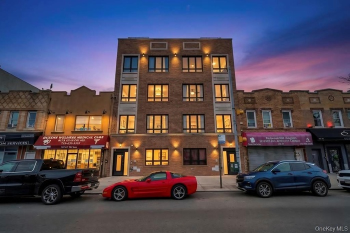 Property at dusk featuring view of commercial area