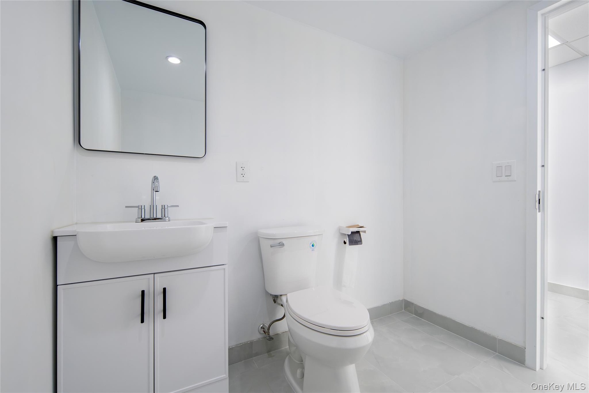 Bathroom featuring vanity and light tile patterned flooring