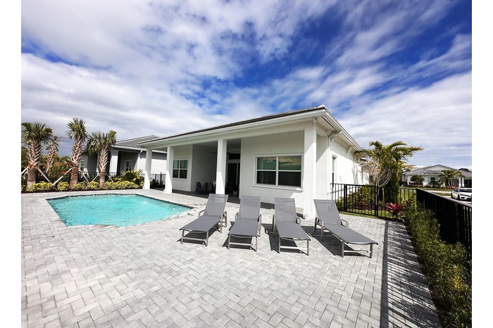 Pool deck and fenced in backyard.