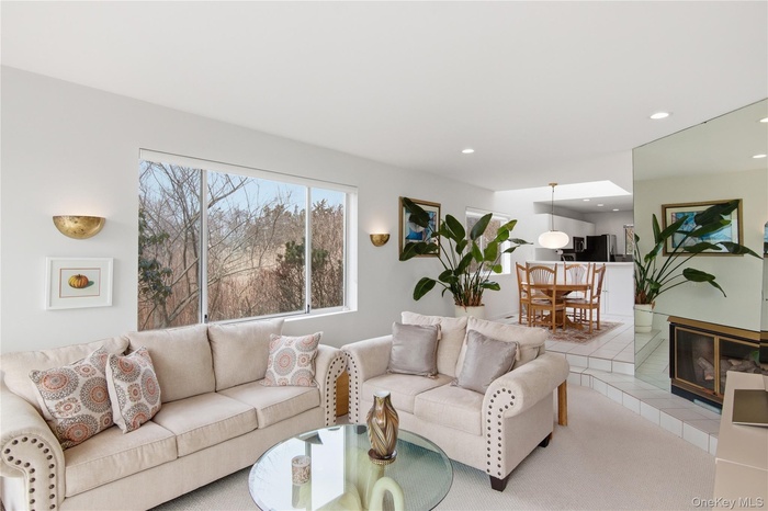 Living area with recessed lighting and a fireplace and water views