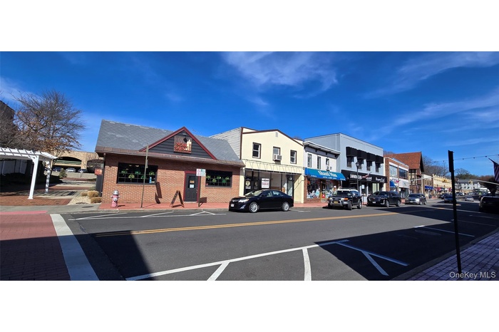 Street view.  the 2 story beige color building is for sale.