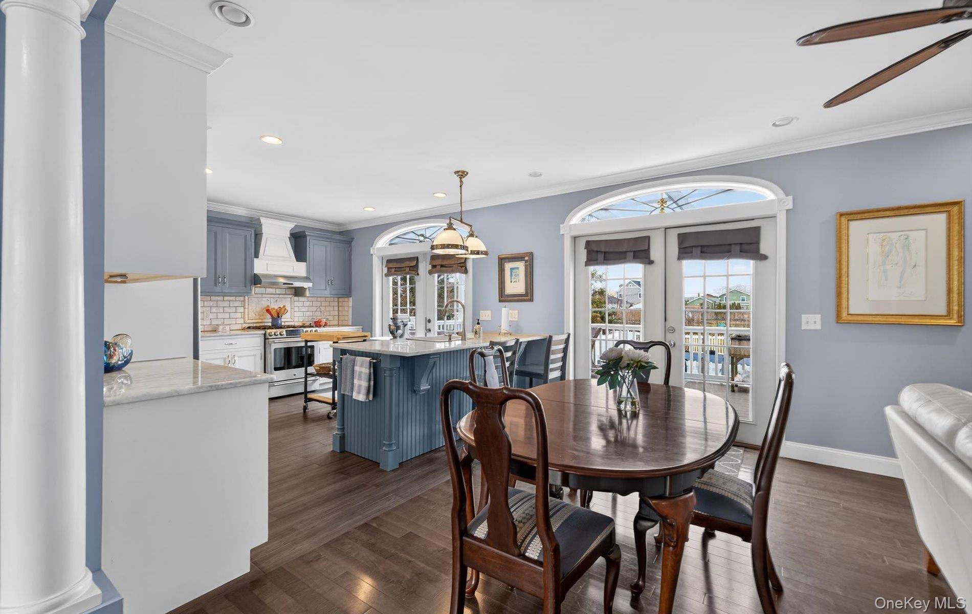 Dining area with french doors, ornamental molding, dark wood-style flooring, recessed lighting, and a ceiling fan