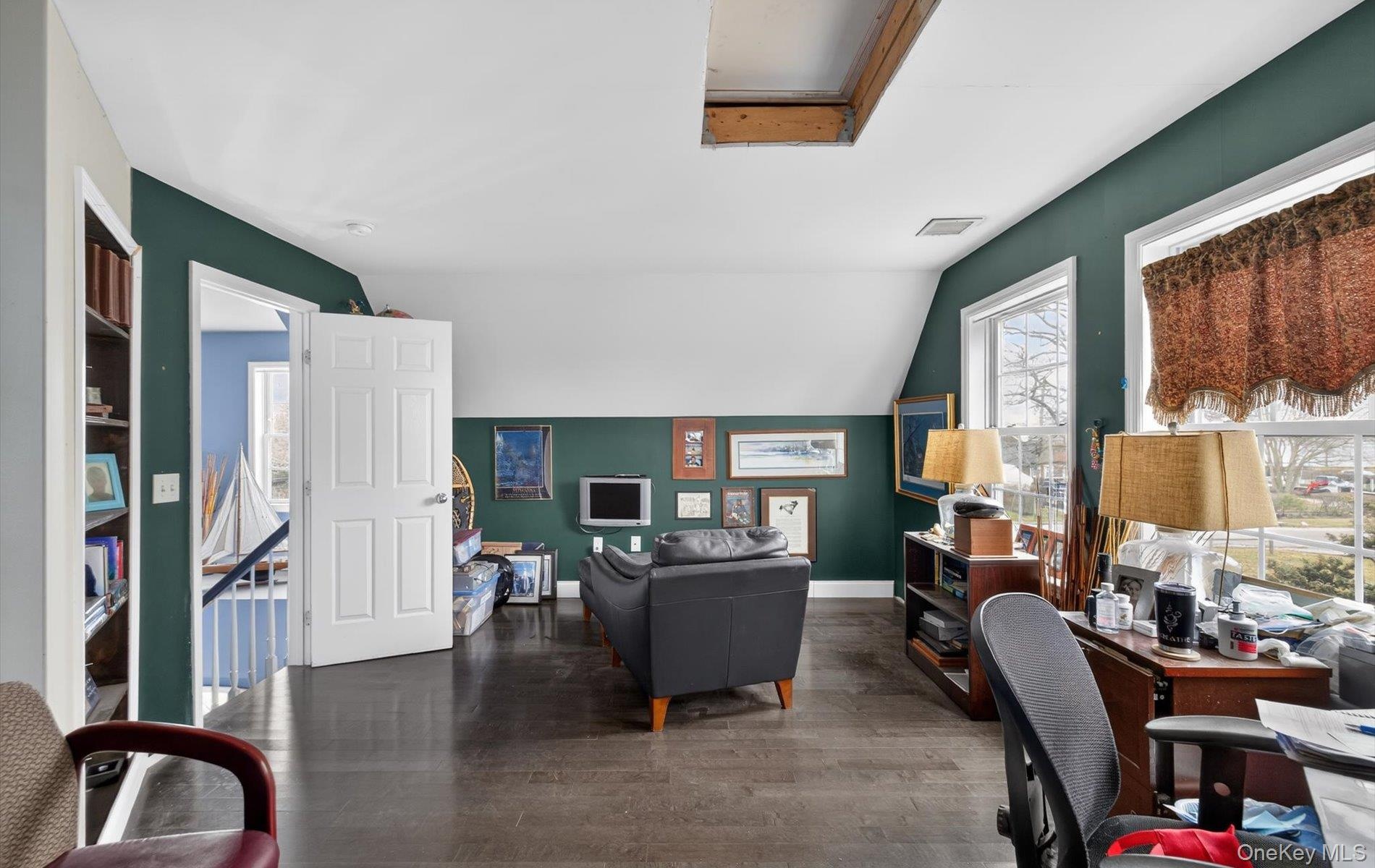 Office featuring lofted ceiling and wood finished floors
