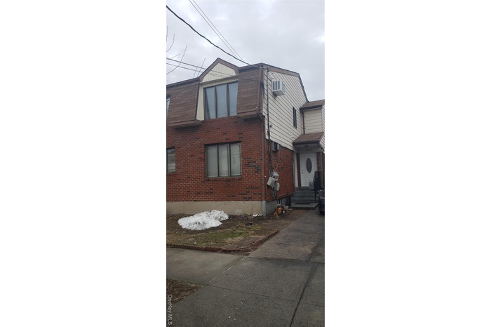 View of side of home featuring brick siding