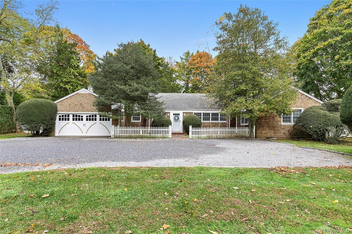 View of front of home featuring a garage and a front yard