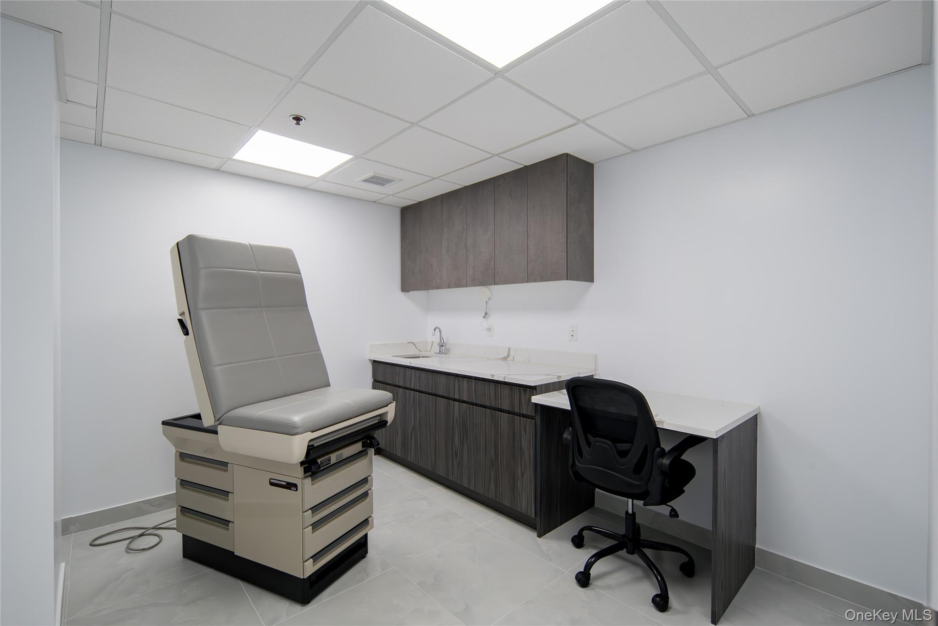 Office featuring a paneled ceiling and baseboards