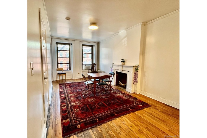 This lovely apartment has original hardwood floors throughout the living room and entry hallway.  The space is beautifully lit by both the morning and