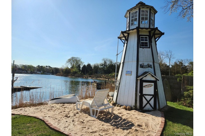 Dock area with a water view and fence
