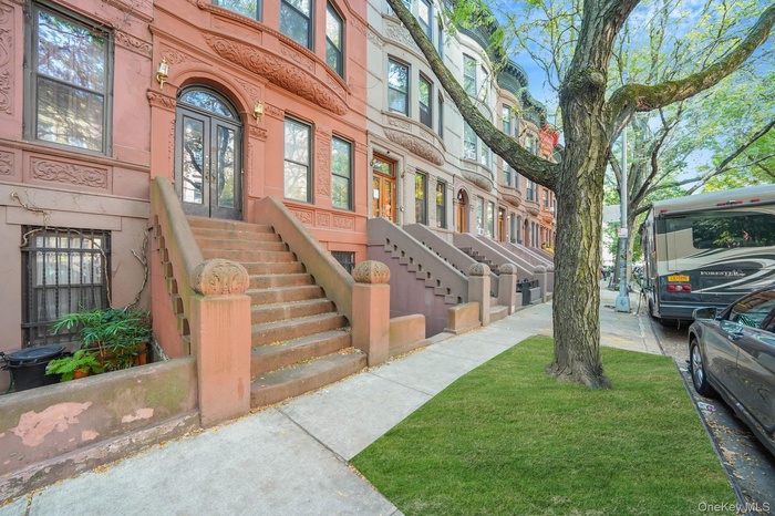 Charming tree-lined block featuring classic brownstone stoops and historic architecture, offering timeless Harlem character and curb appeal.