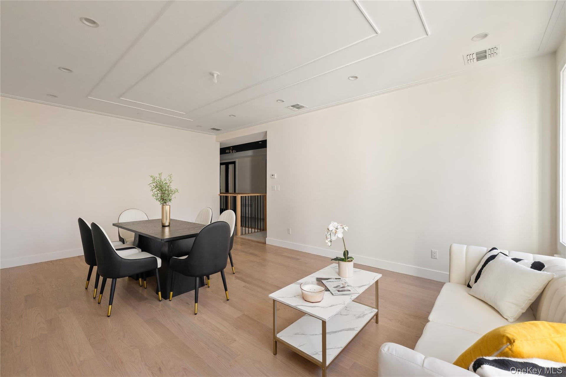 Living room with light wood finished floors and recessed lighting