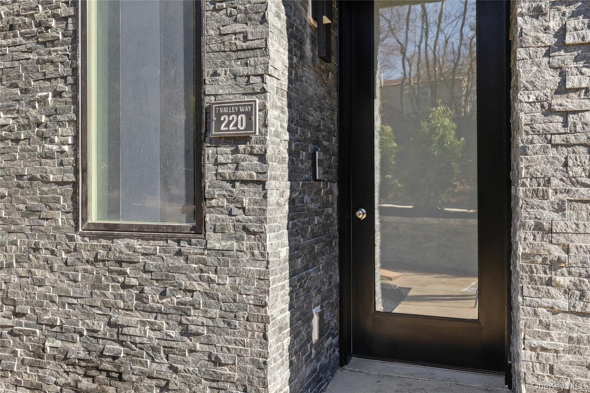 View of exterior entry featuring brick siding