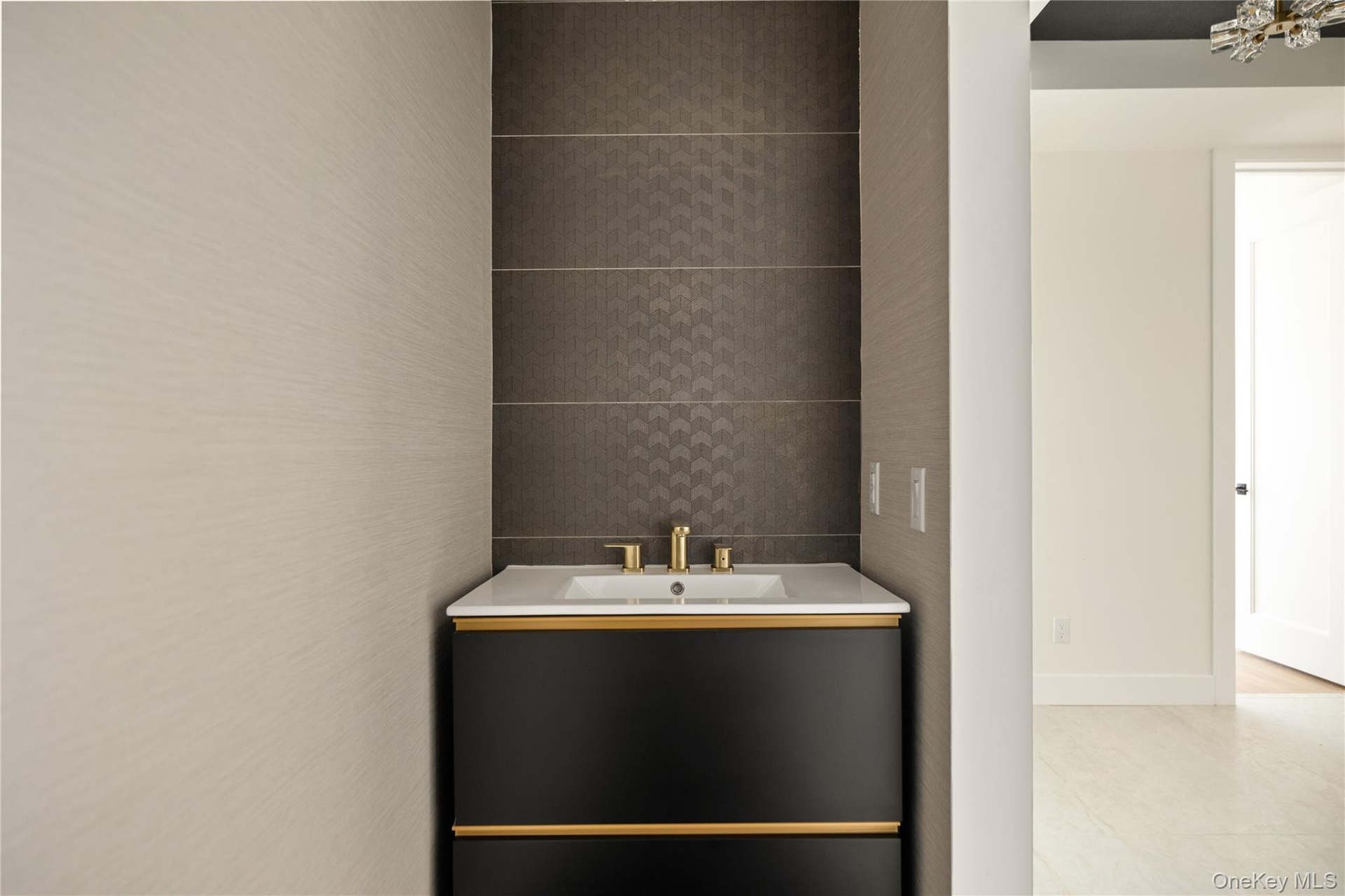 Bathroom with vanity and tile walls