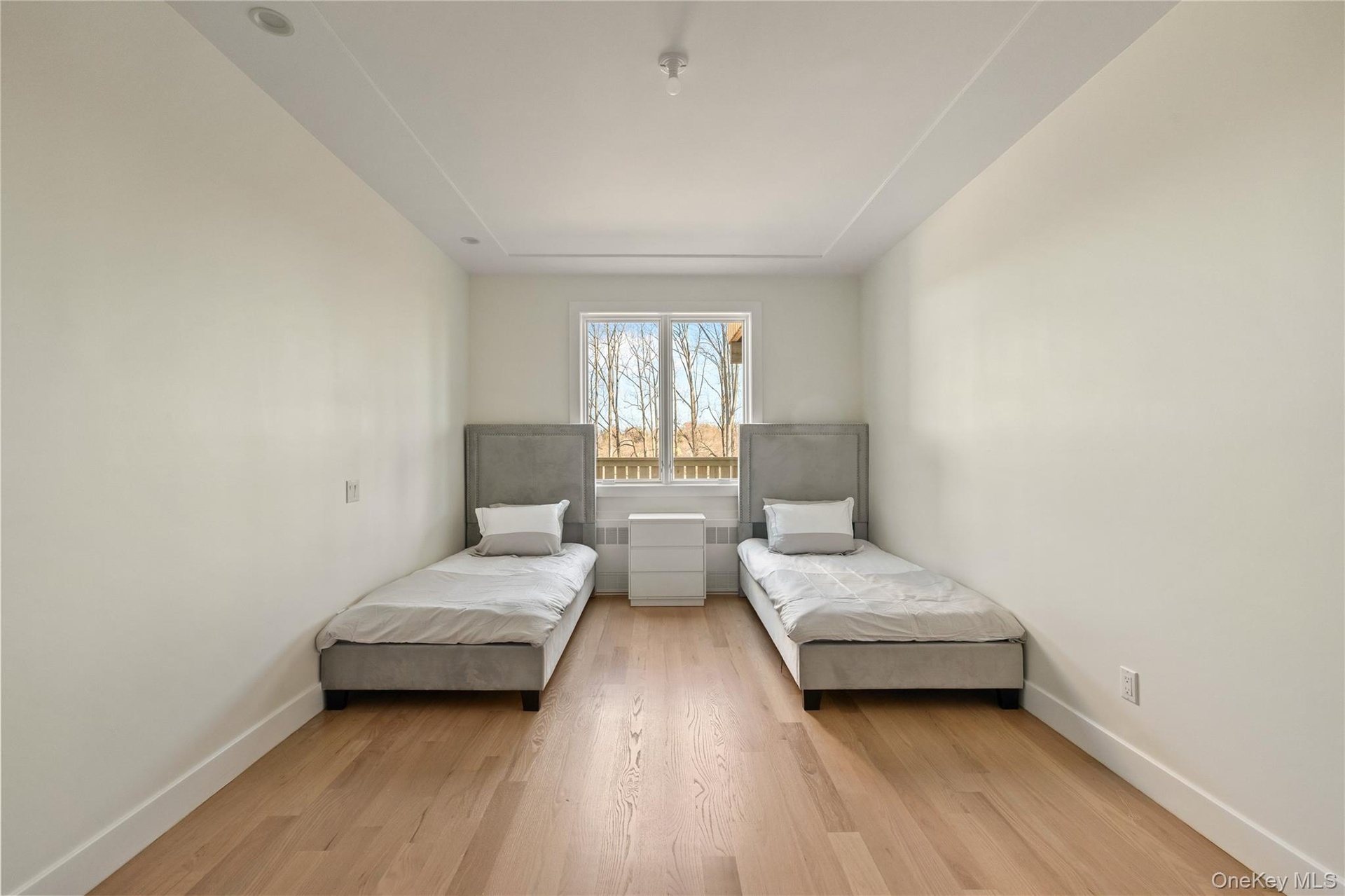 Bedroom with light wood-style floors and baseboards