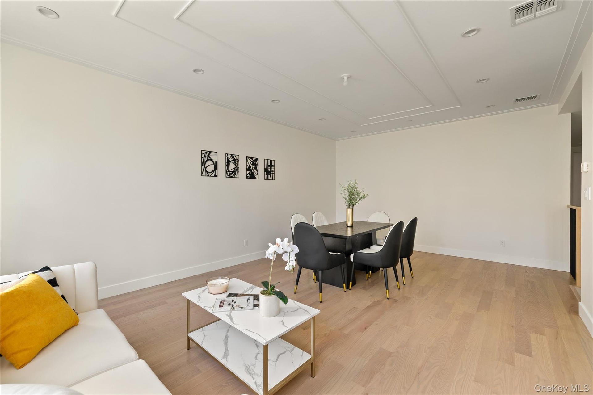 Living area featuring light wood finished floors and recessed lighting