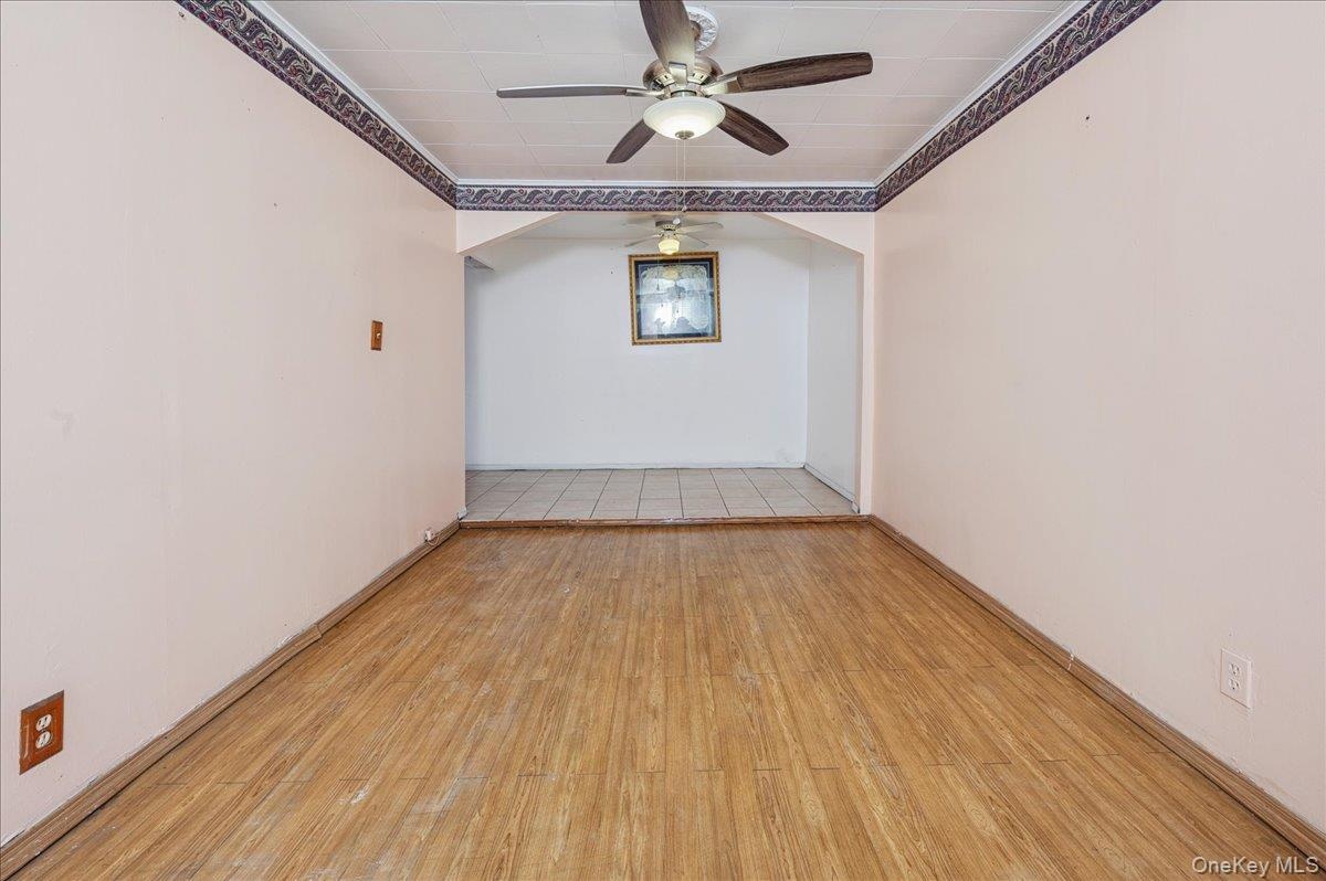 Family room featuring ceiling fan, light wood -type finished floors, and crown molding