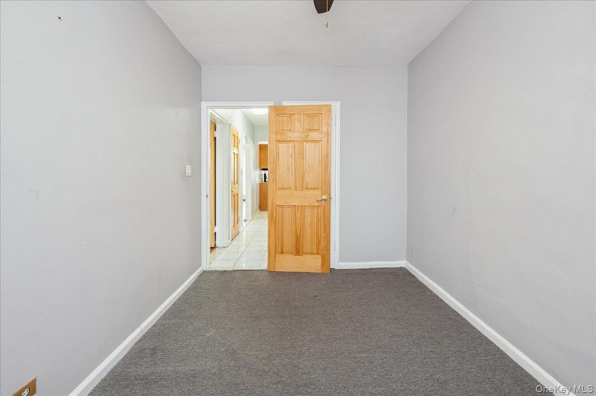 Second bedroom  featuring light carpet and baseboards