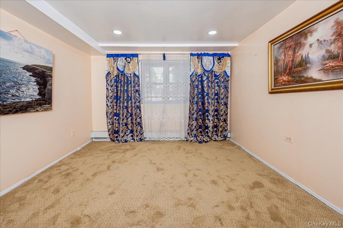 Carpeted third bedroom with baseboards (on first floor)
