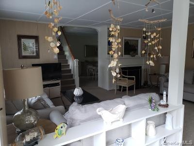 Living area featuring a fireplace and stairs