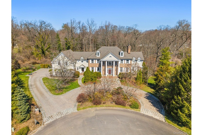 Timeless colonial with exceptional curb appeal and circualr driveway on over an acre of private land at the end of a cul de sac