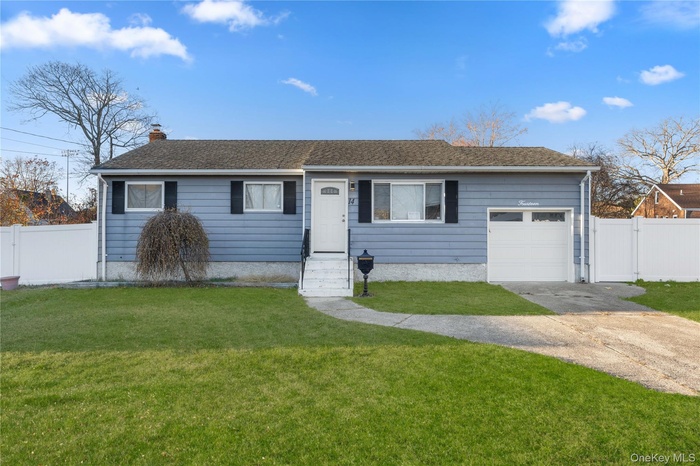 Ranch-style house featuring a gate, concrete driveway, and a garage