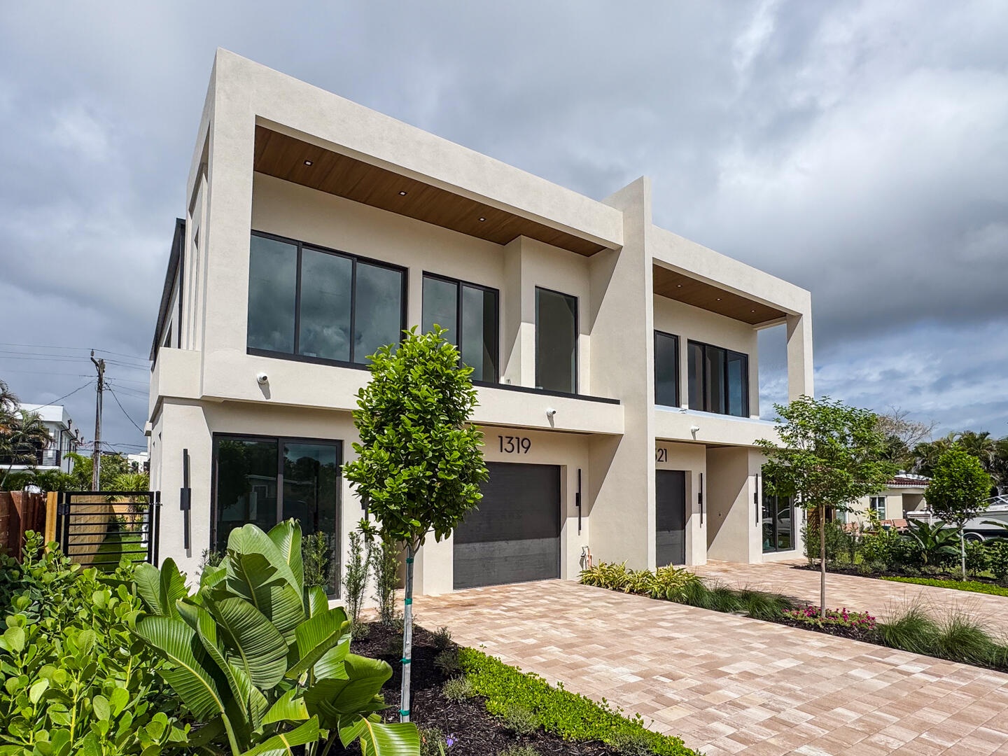 (as of April 8, 2026) Front elevation facing East. Beautifully landscaped. Modern with warm tones and dimension. Featuring full-height windows through