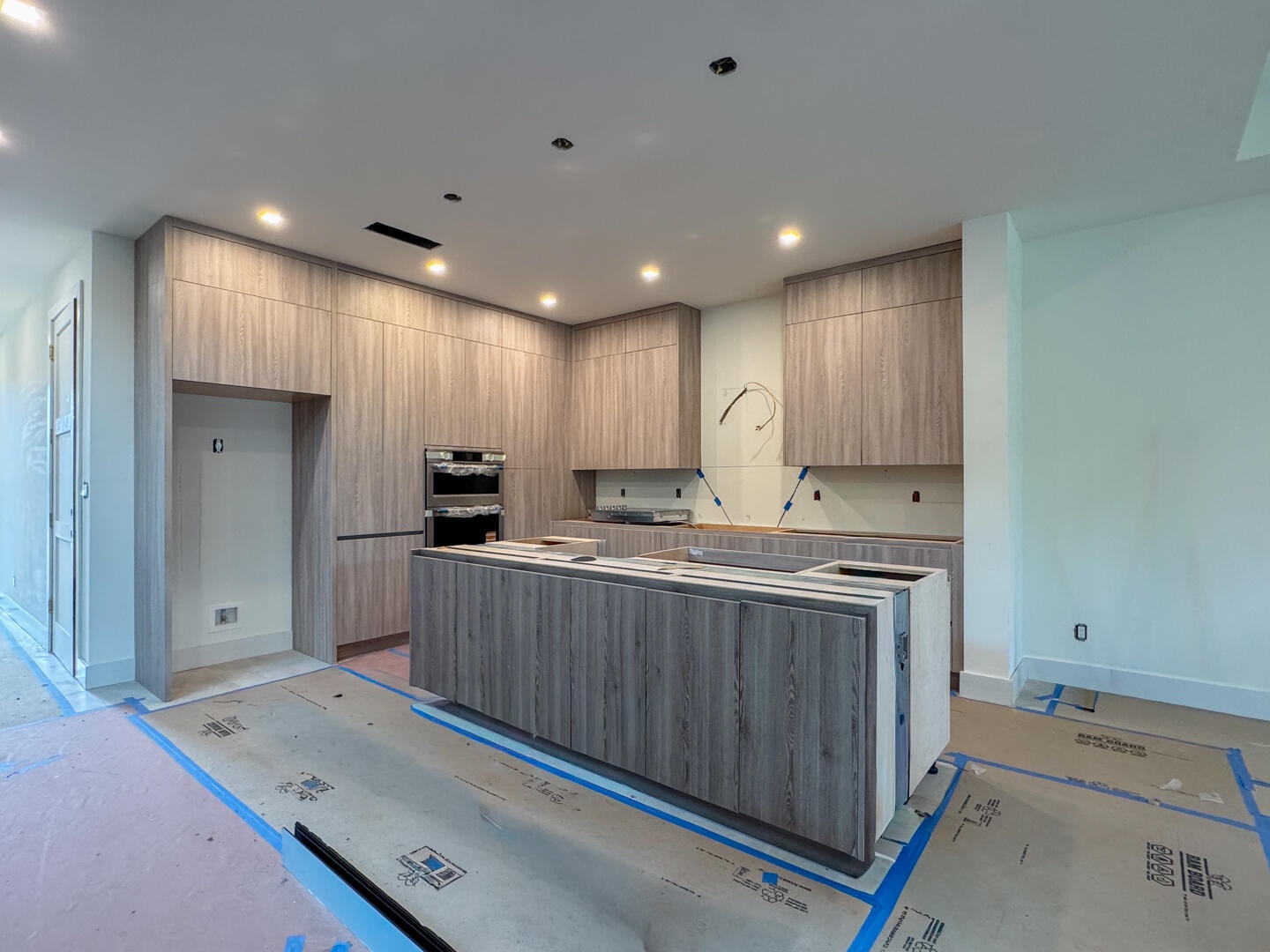 (as of April 8, 2026) the kitchen anchors the first floor living space, quartz countertops to be installed, featuring kitchen aid professional applian