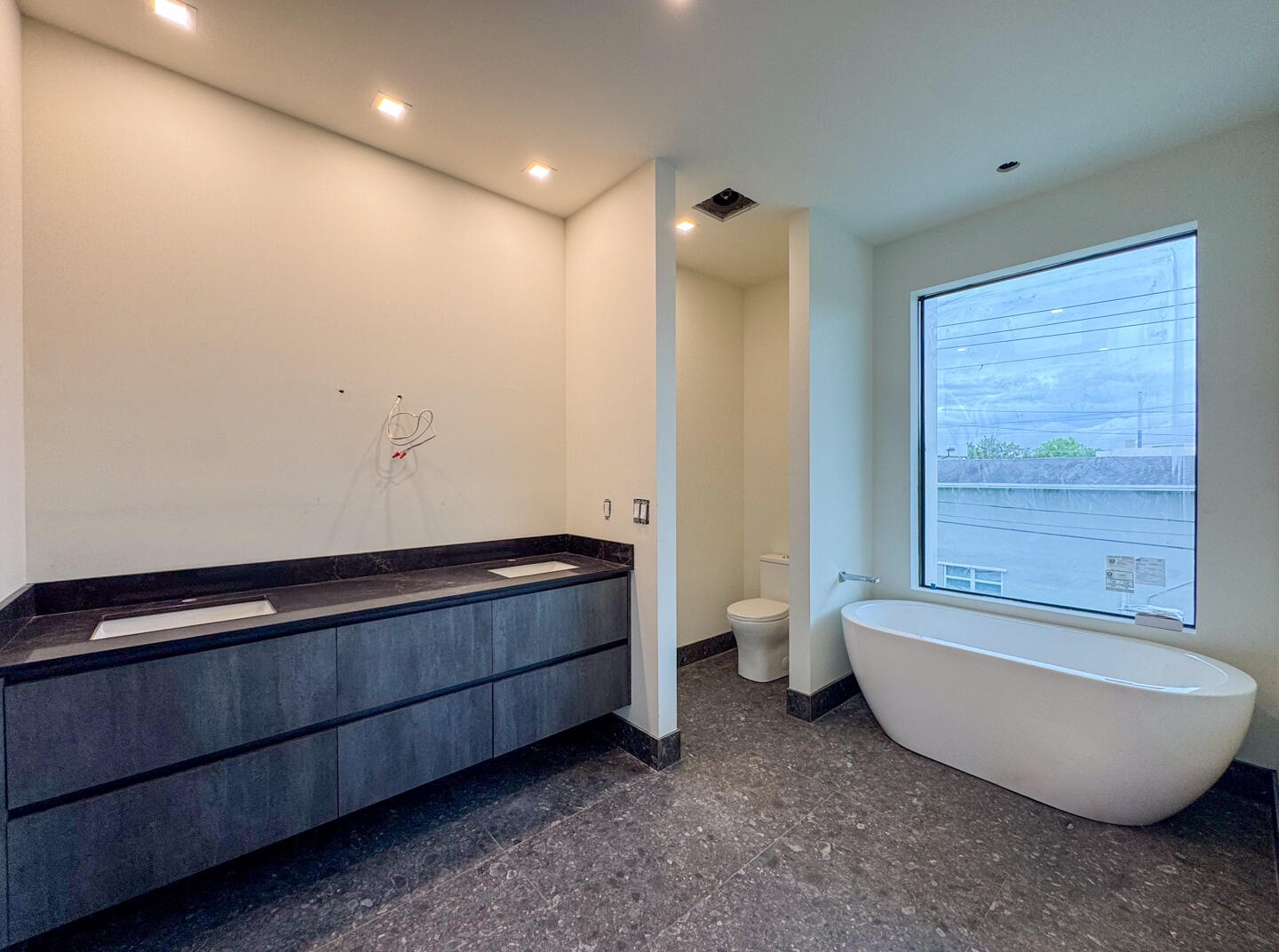 (as of April 8, 2026) the primary bath includes a double vanity, an oversized shower, and freestanding tub, both controlled with Kohler's Anthem Digit