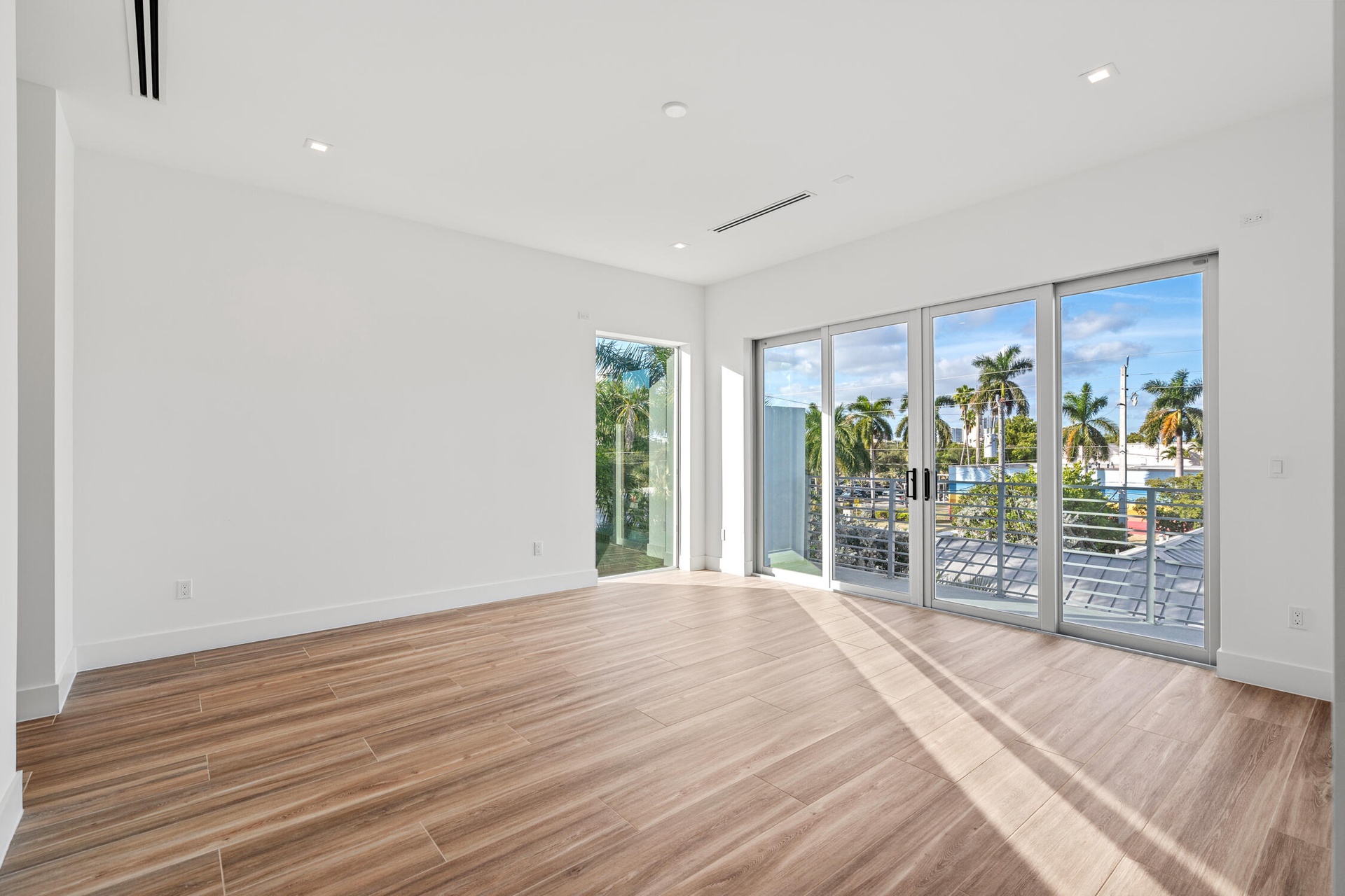 Natural light cascades throughout this exceptional corner unit primary bedroom.