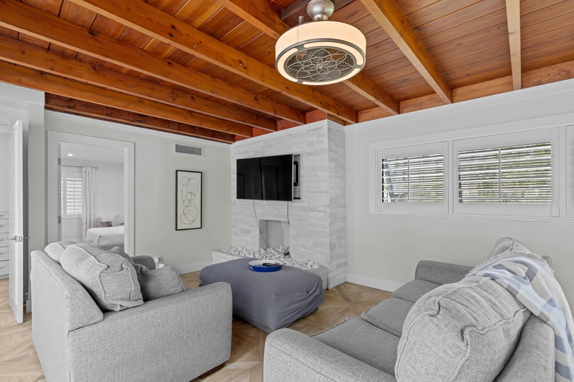 Living room with exposed beam ceilings.