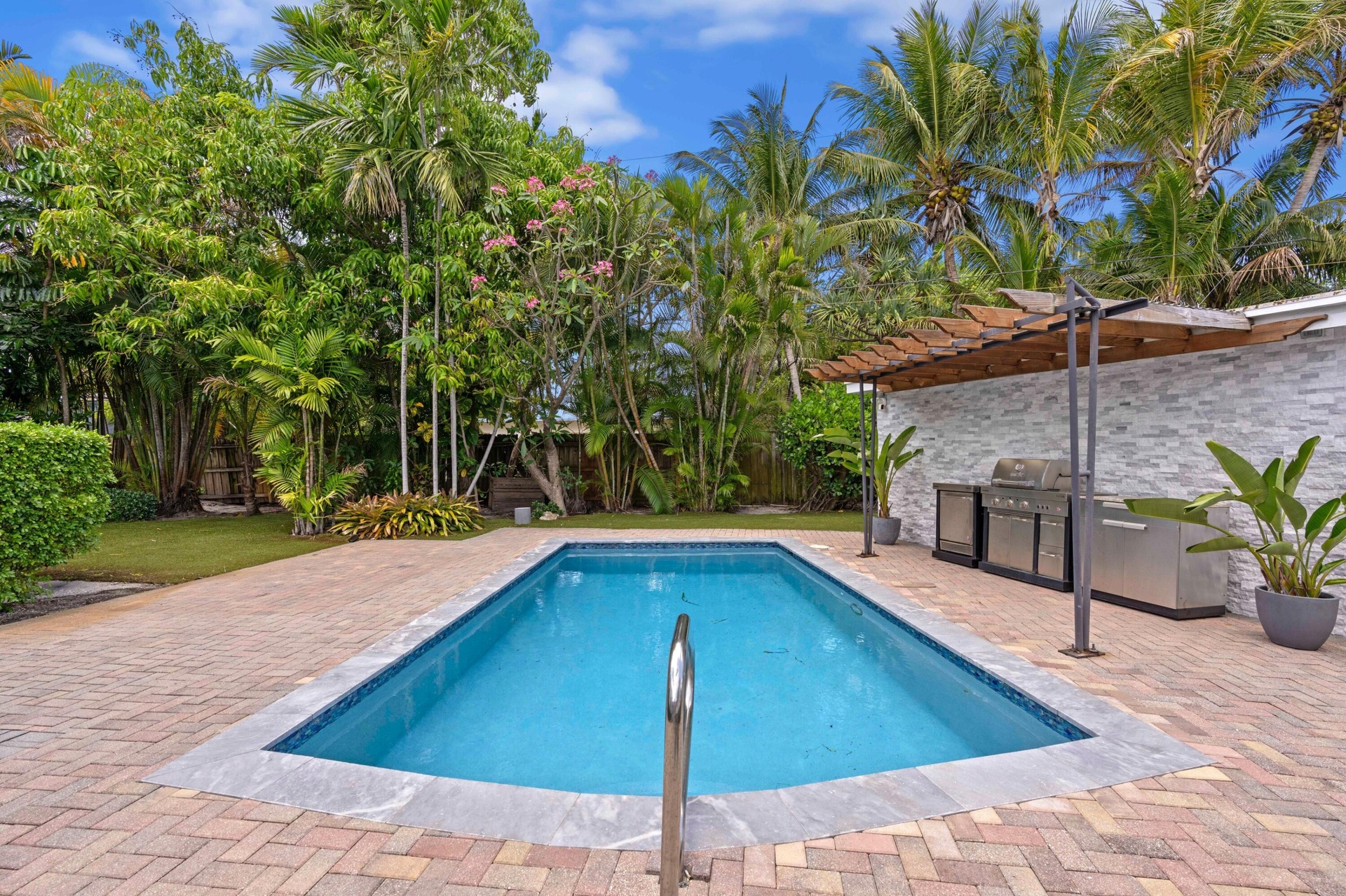 Back patio, pool, and outdoor kitchen.