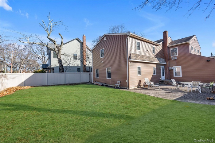 Back of property with a patio and entry steps