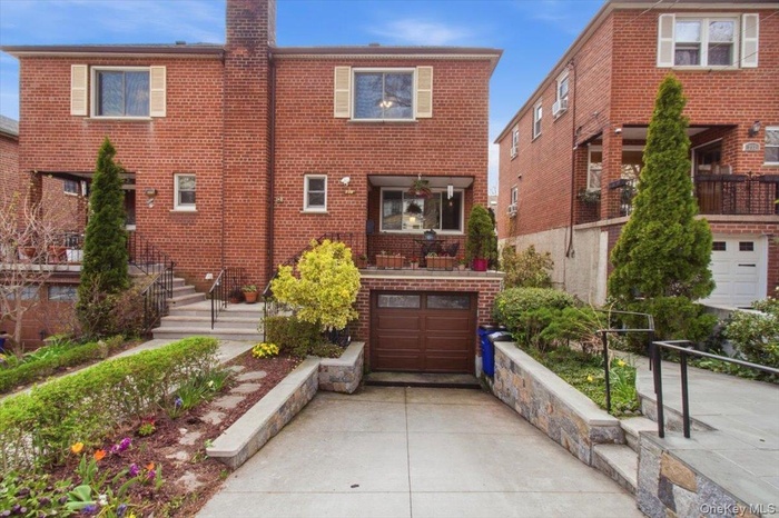 The property features a brick exterior with a driveway leading to an integrated garage