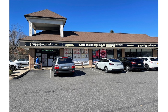 View of property featuring uncovered parking