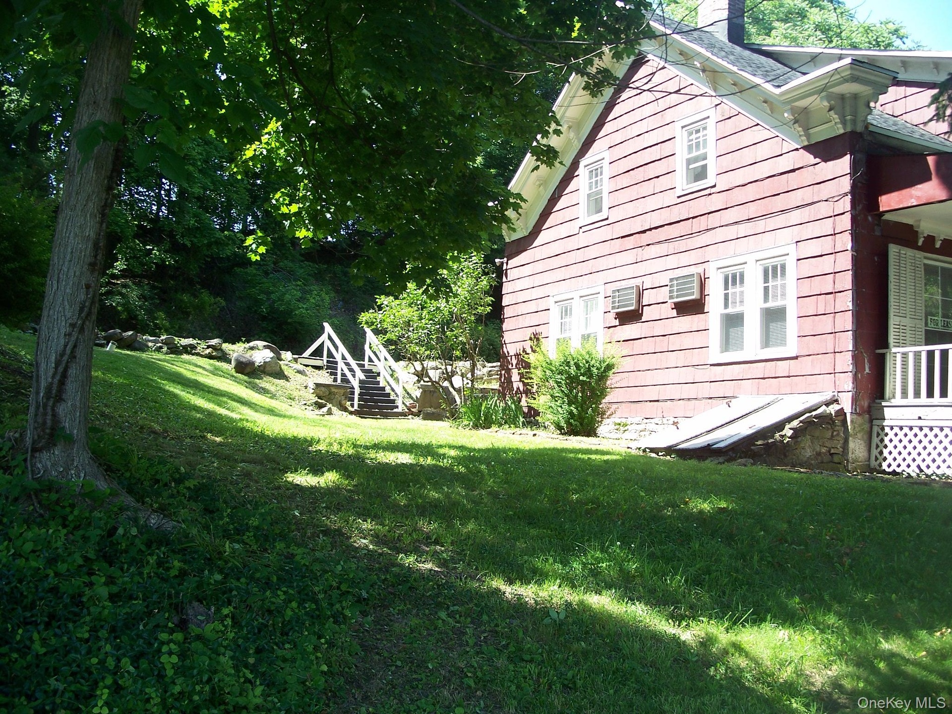 View of home's exterior featuring a lawn and a chimney