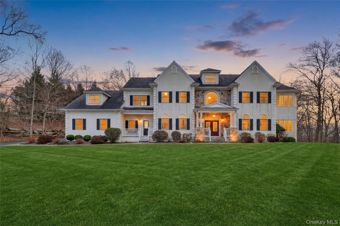Twilight view of a premier home in Willow Ridge offering 10 ft ceilings on the main level with a wonderful conservatory, 9 ft. ceilings on the upper l