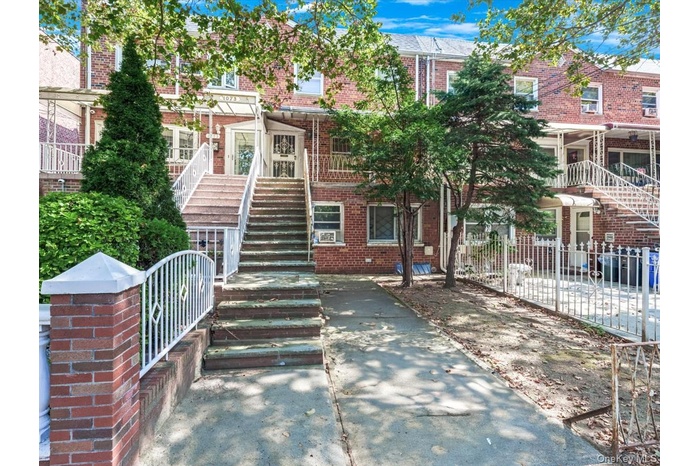 View of front of home with stairway and brick siding