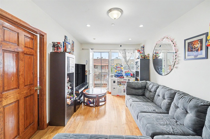 Living room with light wood-style floors and recessed lighting