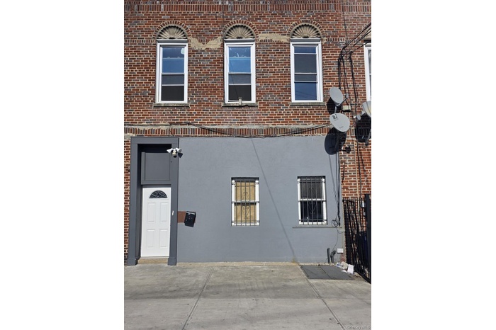 View of property exterior with brick siding