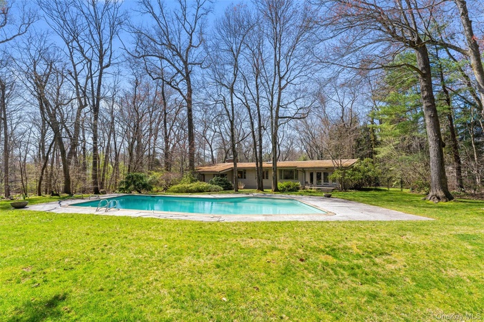 Nearly 2 acres of pure tranquility in the heart of the Murray Hill Estates