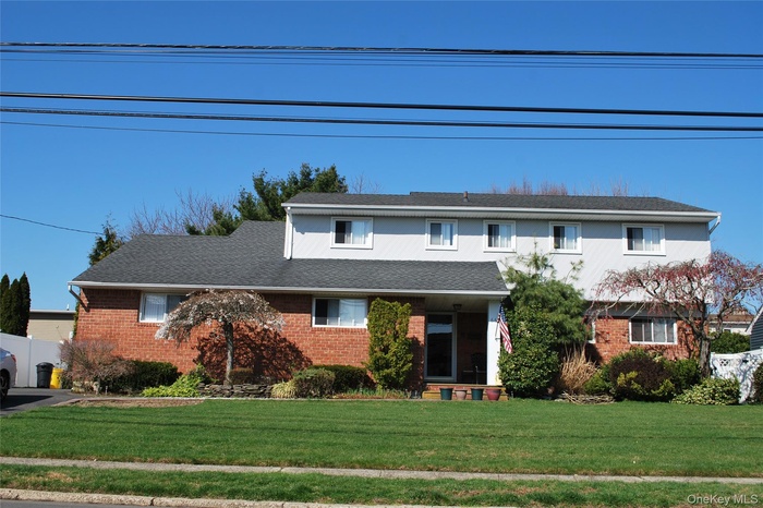 The property features a brick and light-colored siding exterior, with a dark-shingled roof
