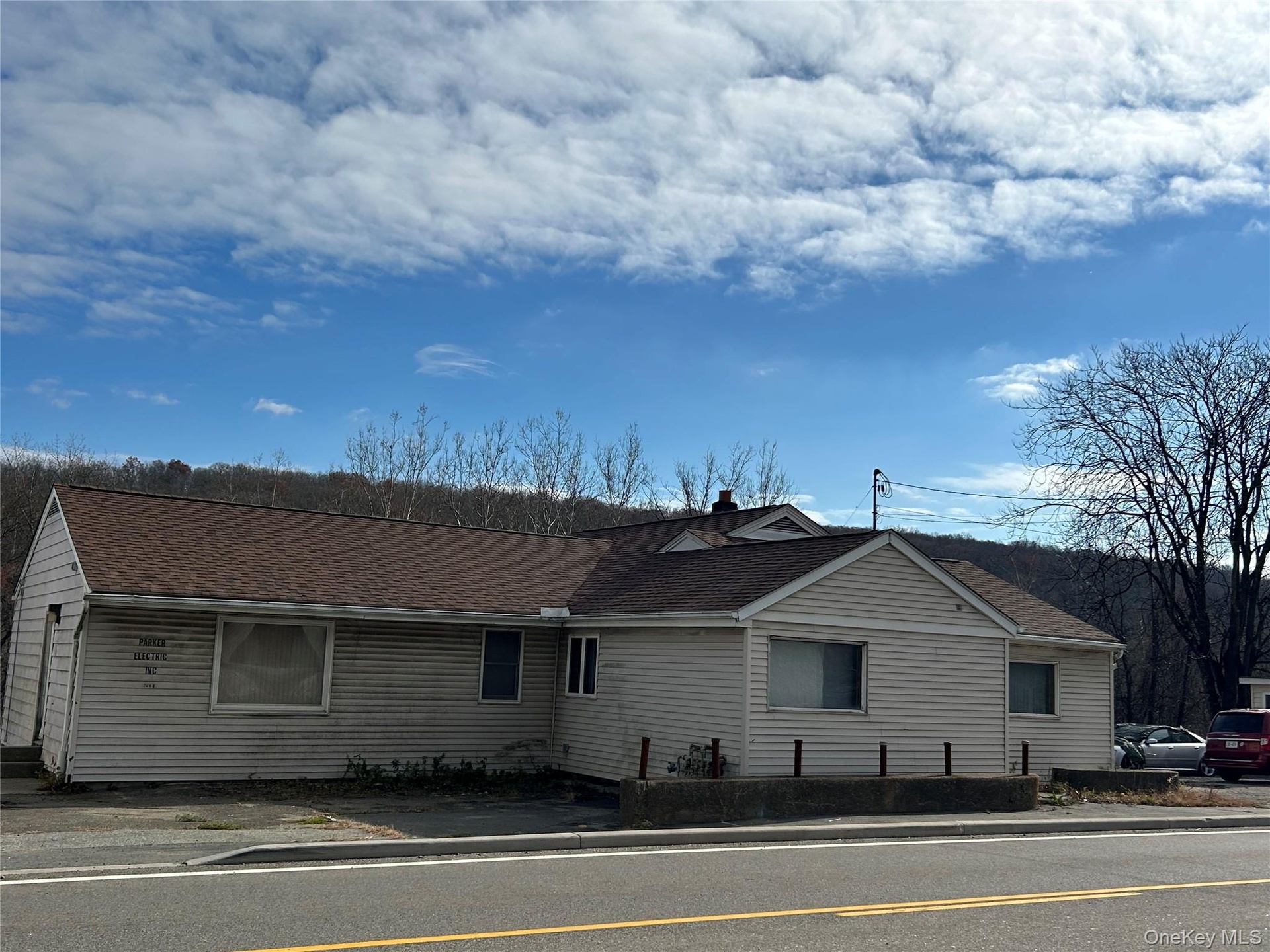 View of front facade featuring roof with shingles