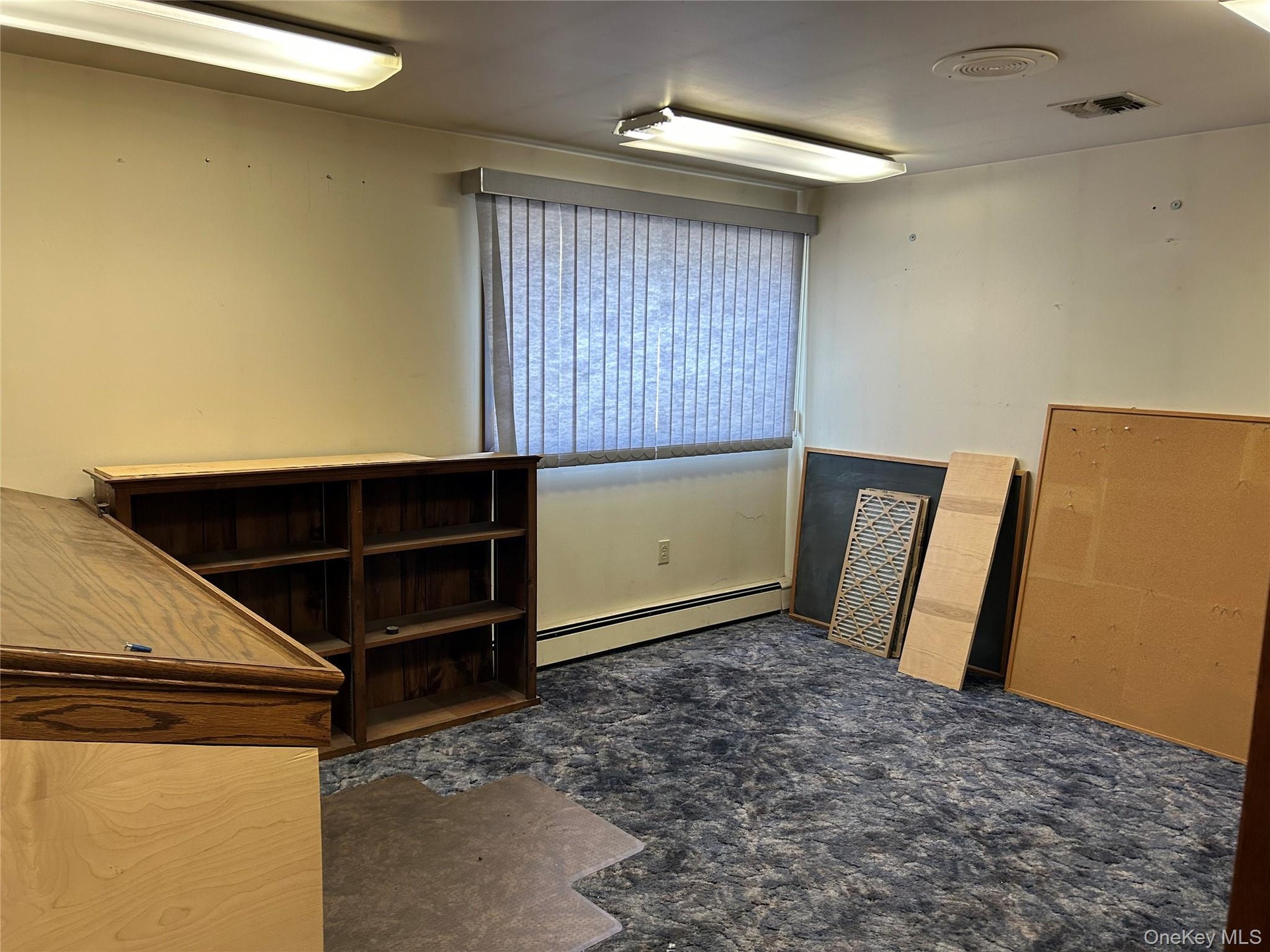 Unfurnished office featuring a baseboard heating unit
