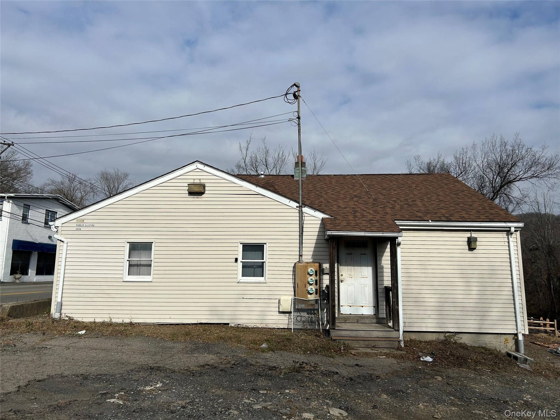 Back of property with roof with shingles