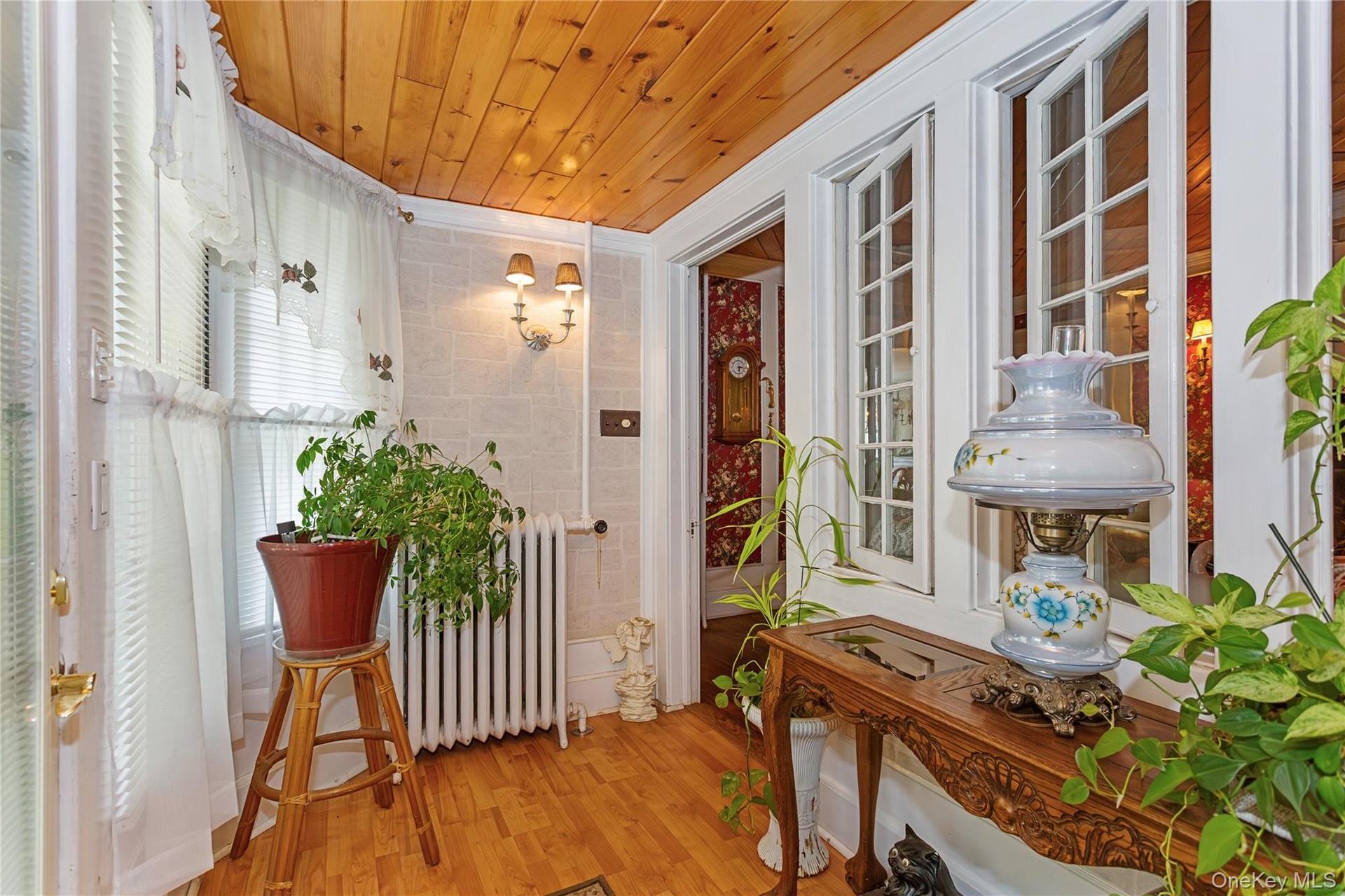 Sunroom / solarium featuring radiator heating unit