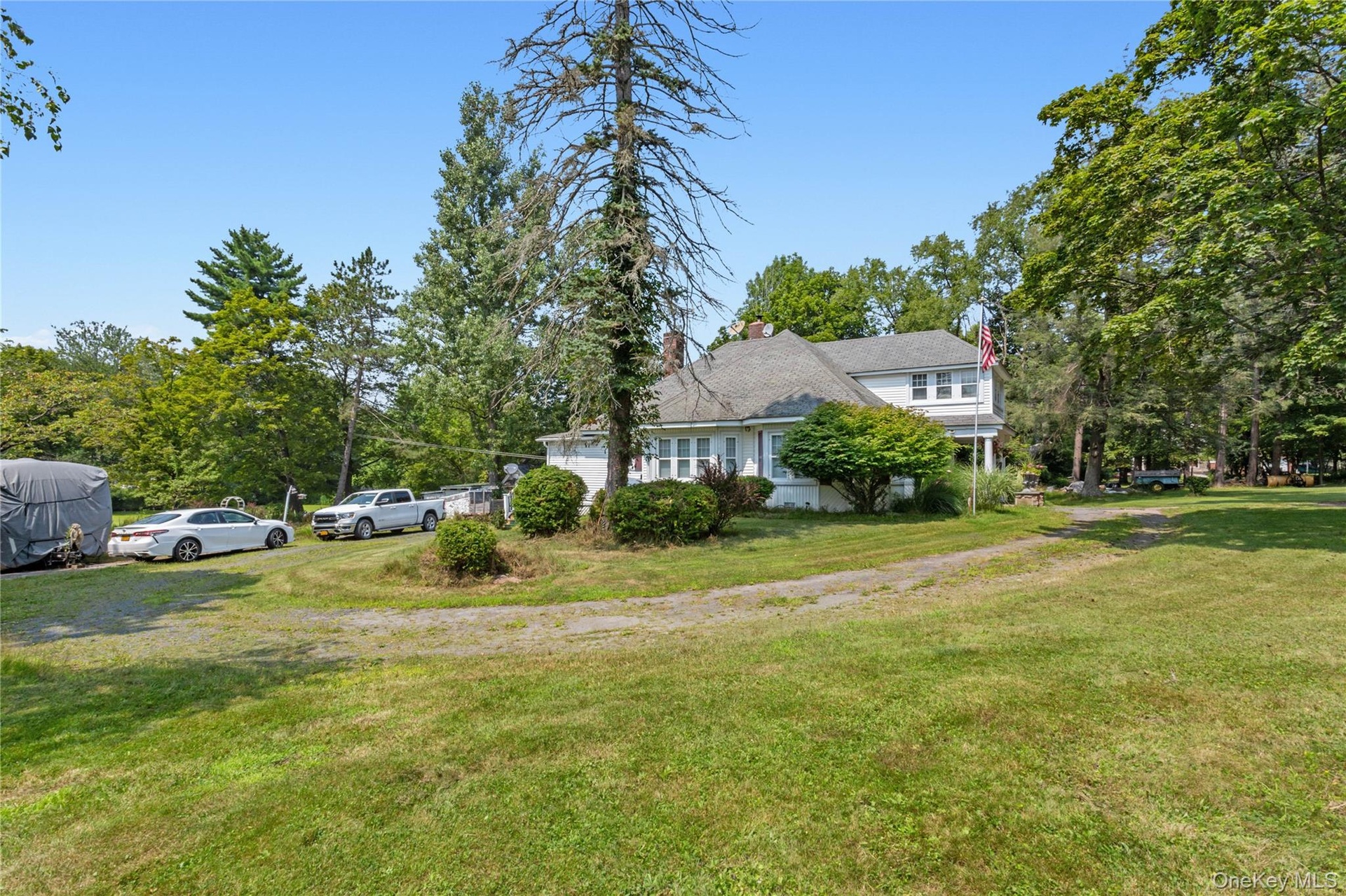 View of home's exterior featuring a yard and a chimney