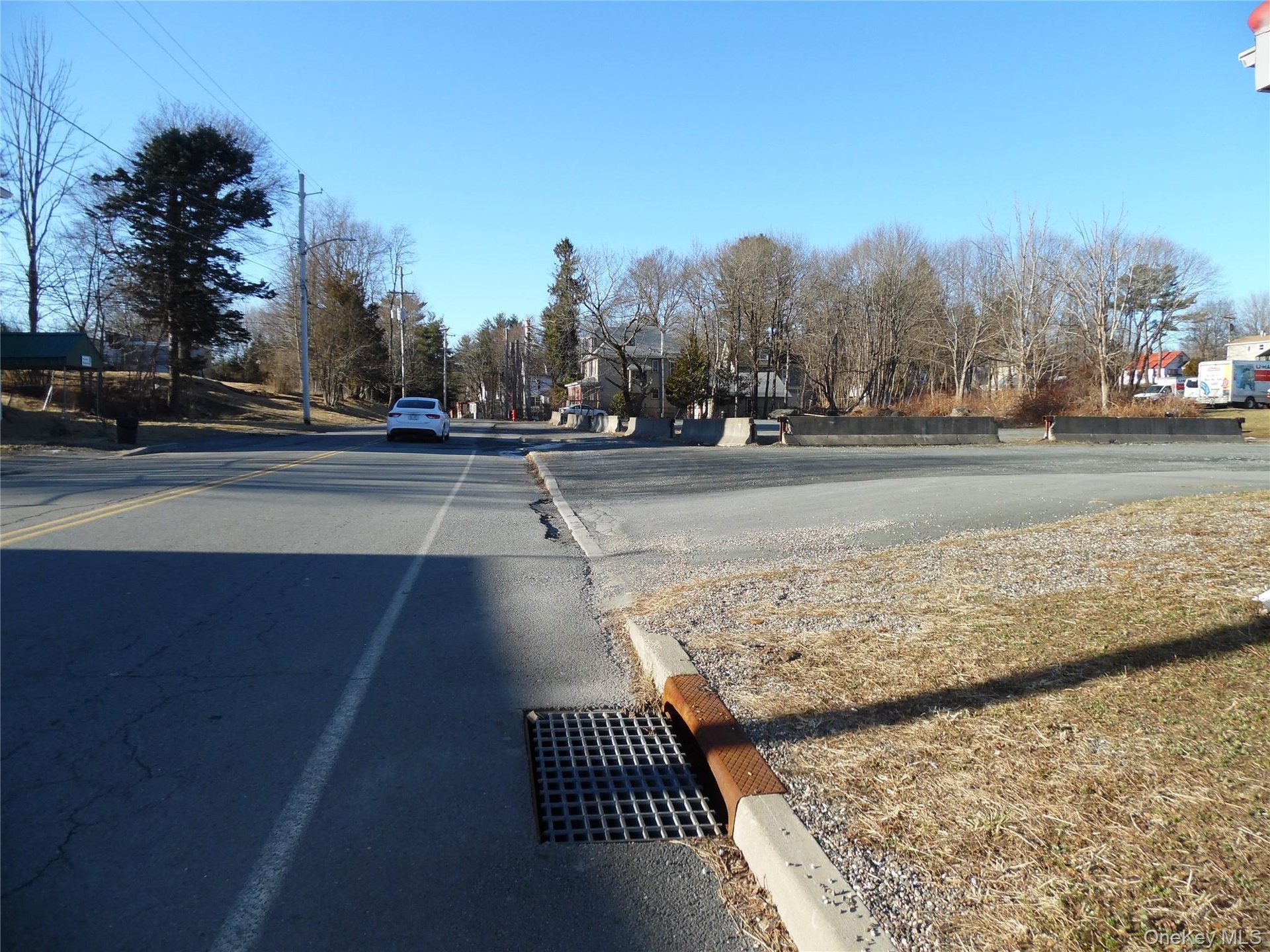 View of asphalt road with curbs