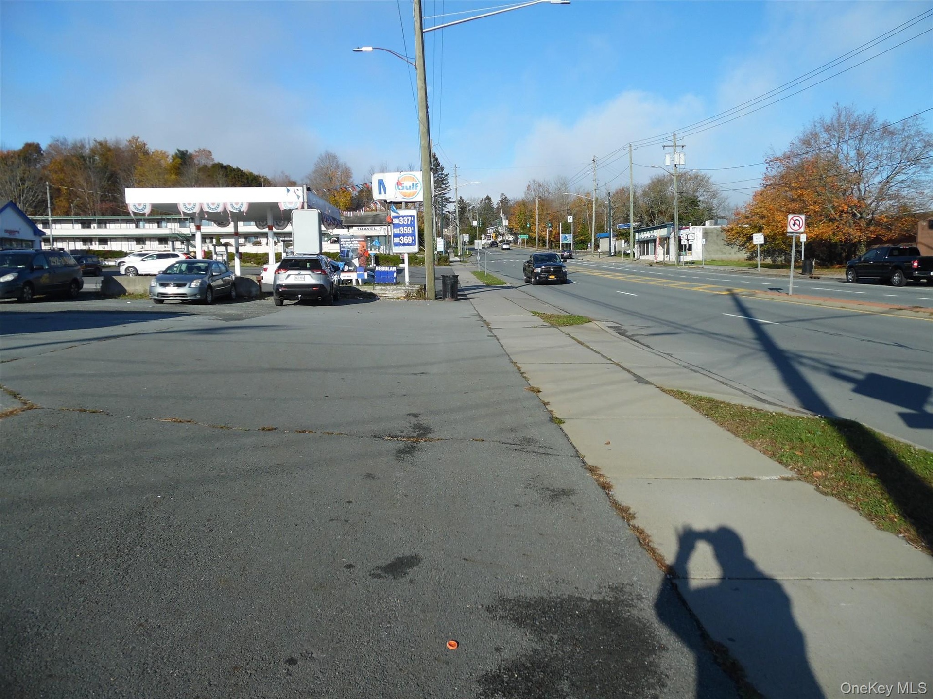 View of asphalt street with traffic signs and sidewalks