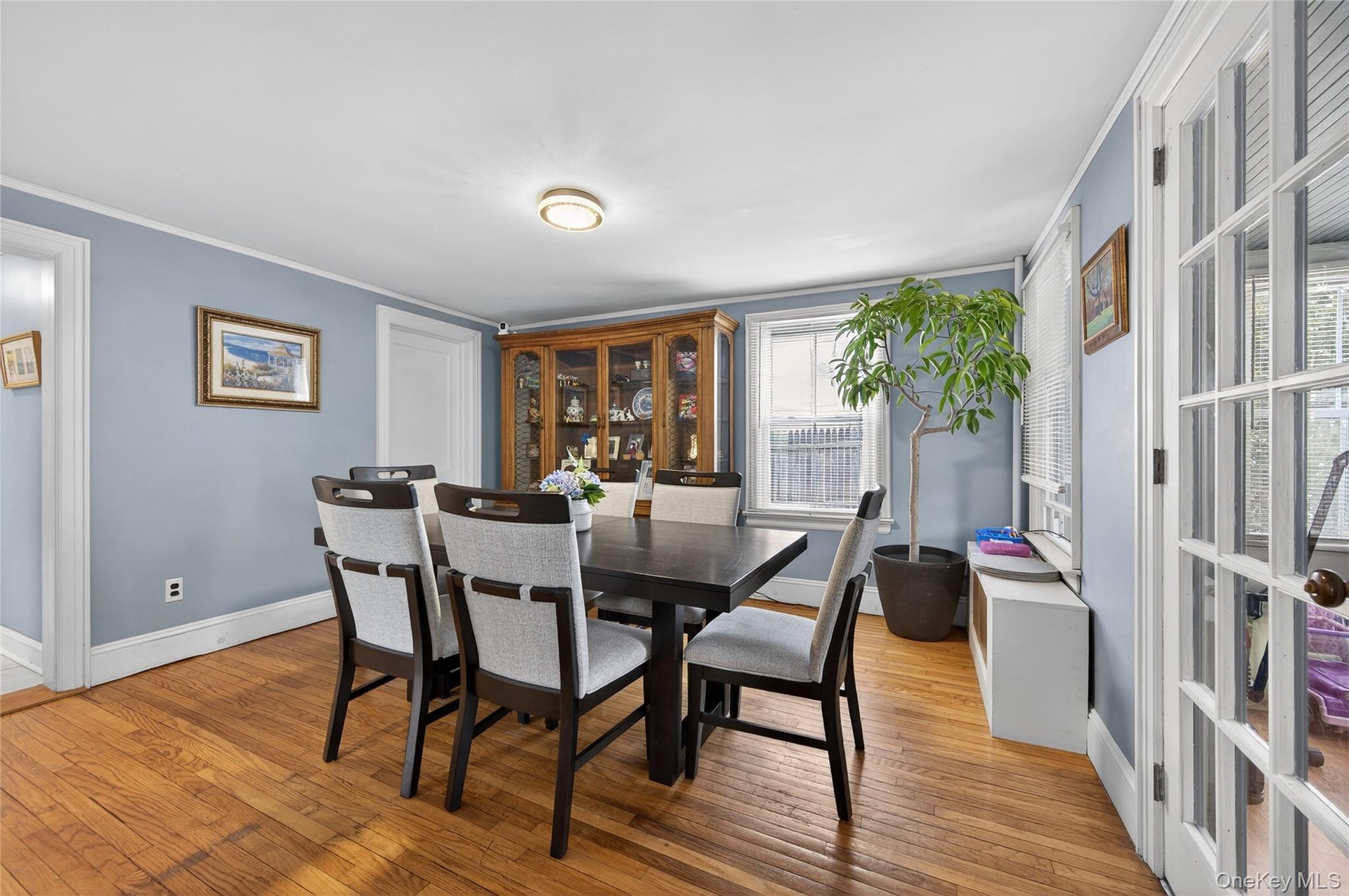 Formal Dining Room with hardwood floors, multiple windows and access to porch.