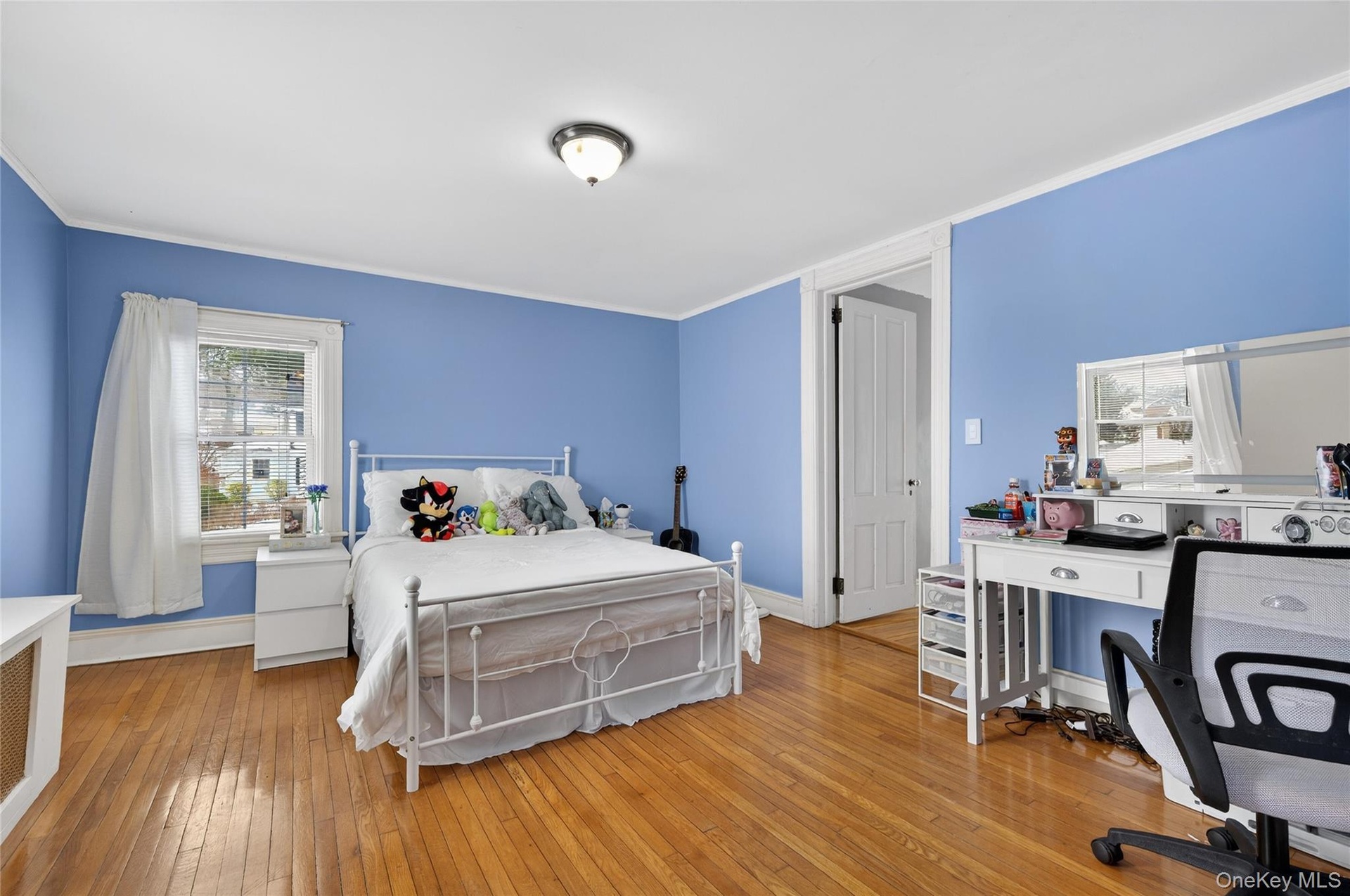 Third bedroom with hardwood floors and mouldings.