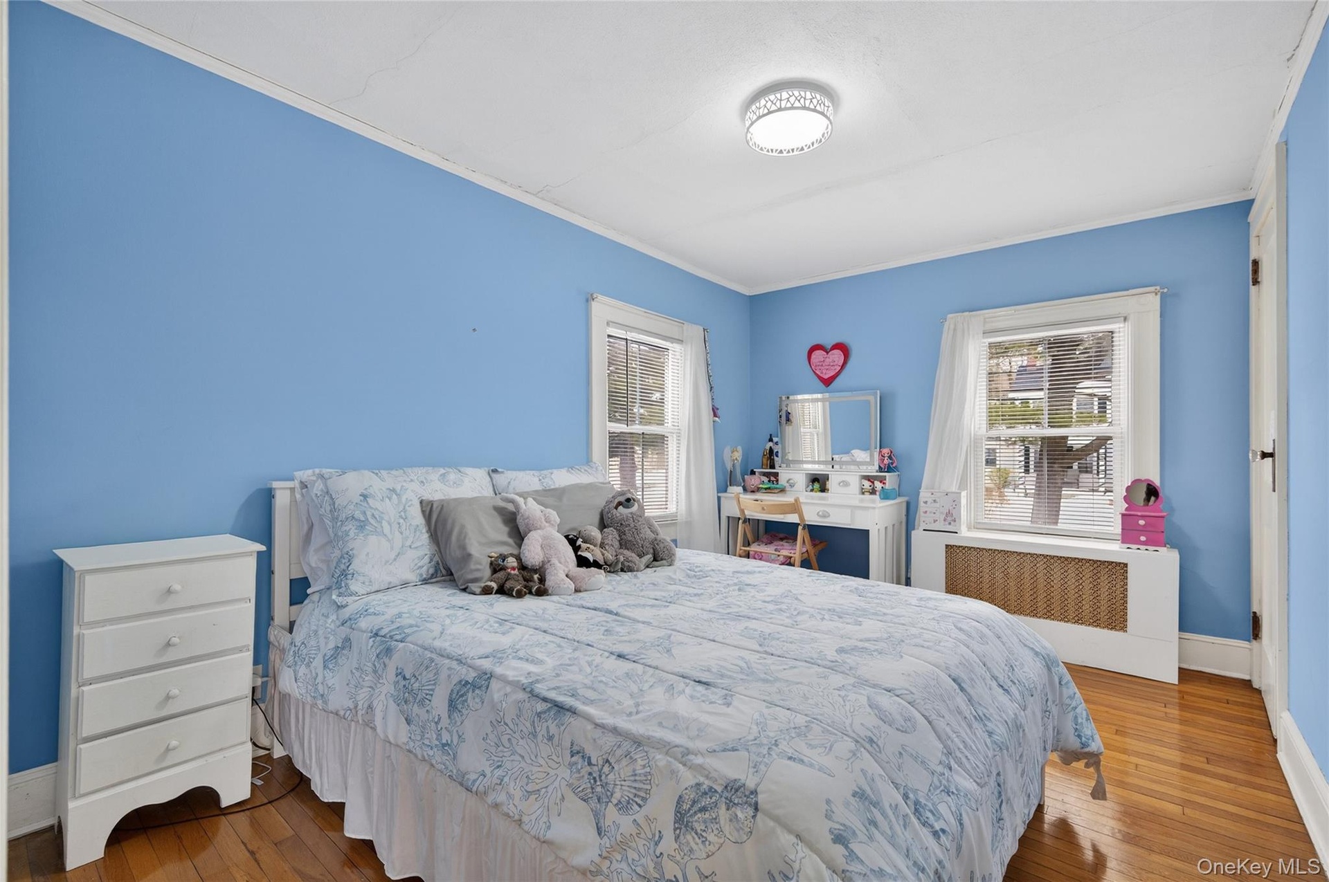 Second bedroom with hardwood floors and windows to the front.